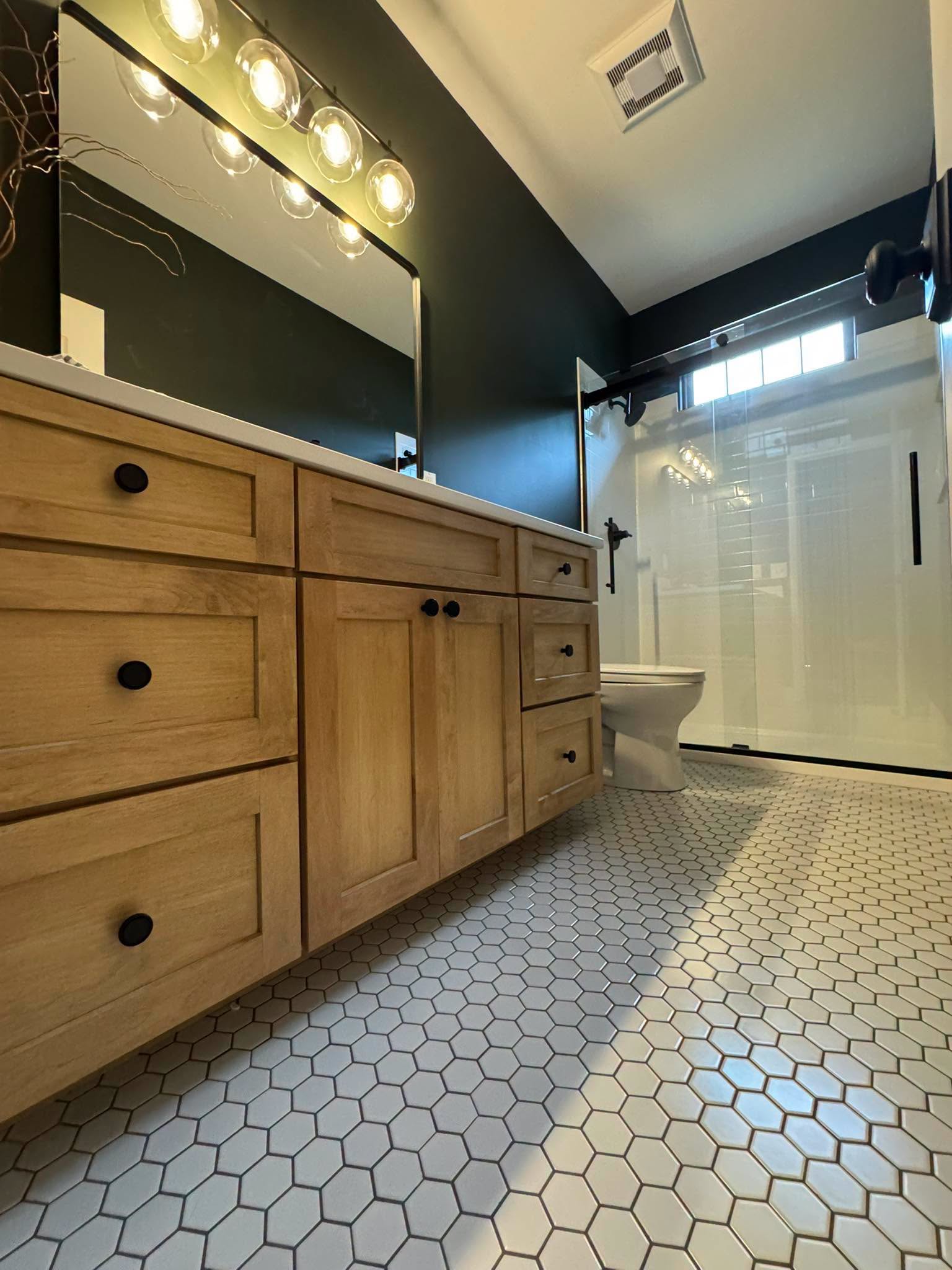 Wood-tone vanity, black hardware; brand gallery inspiration