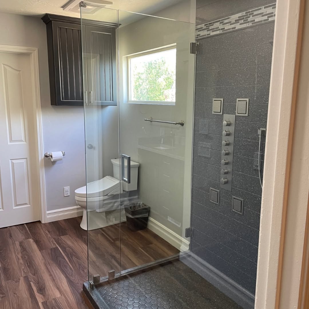 Glass walk-in shower, speckled tile; brand gallery inspiration