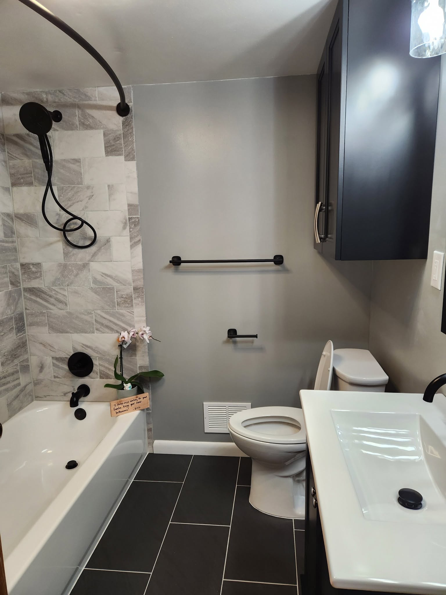 Marble-tiled tub surround, matte black; brand gallery inspiration