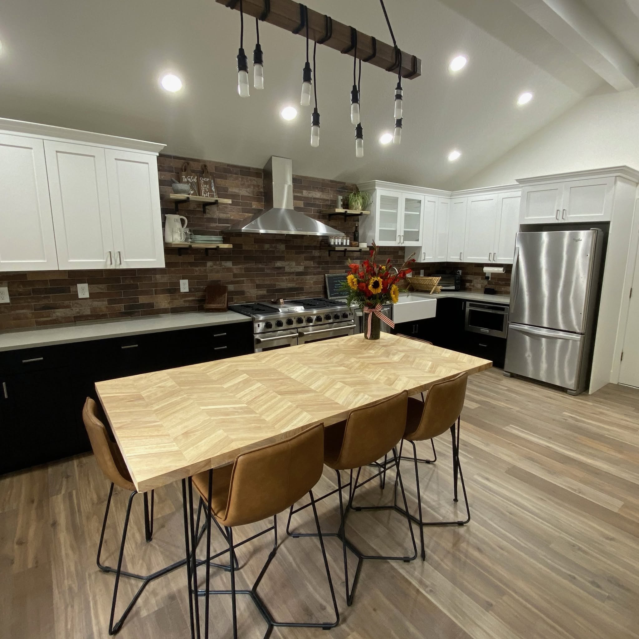 Two-tone cabinetry, brick backsplash; brand gallery inspiration